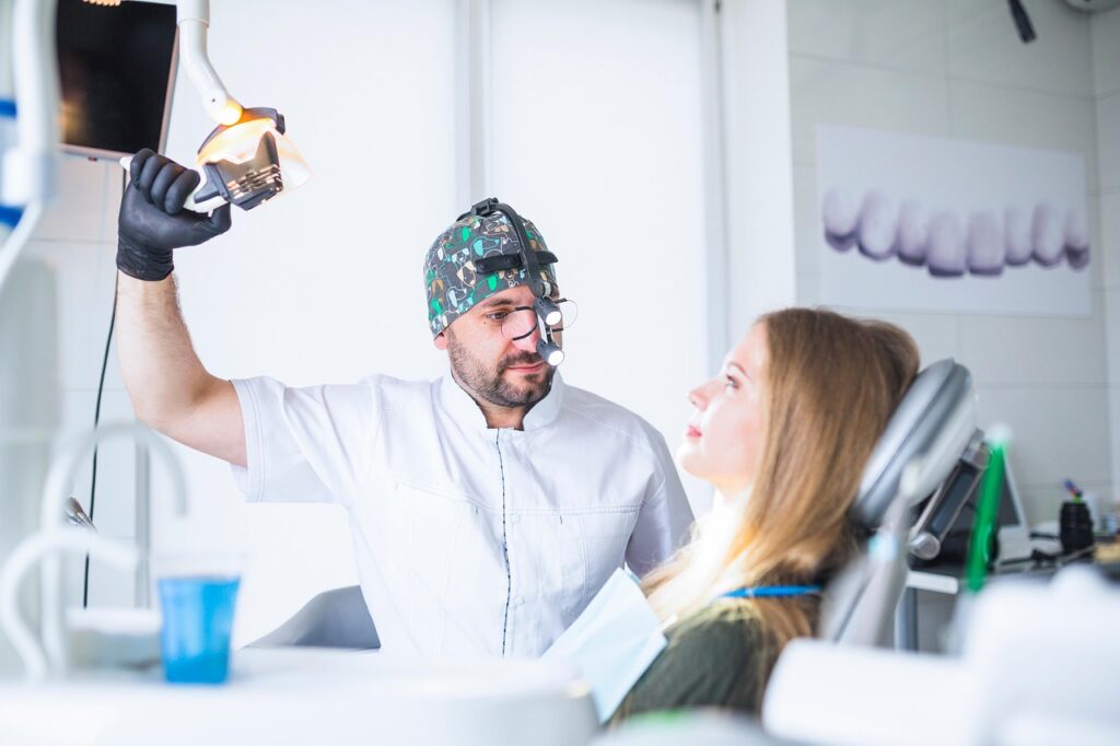 Dentist examining a patient’s teeth during consultation
