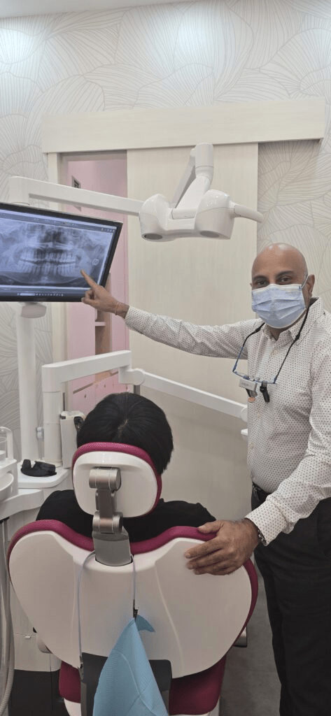 Dr Prashanth performing a dental check-up on a patient at his clinic in Orchard Road, Singapore