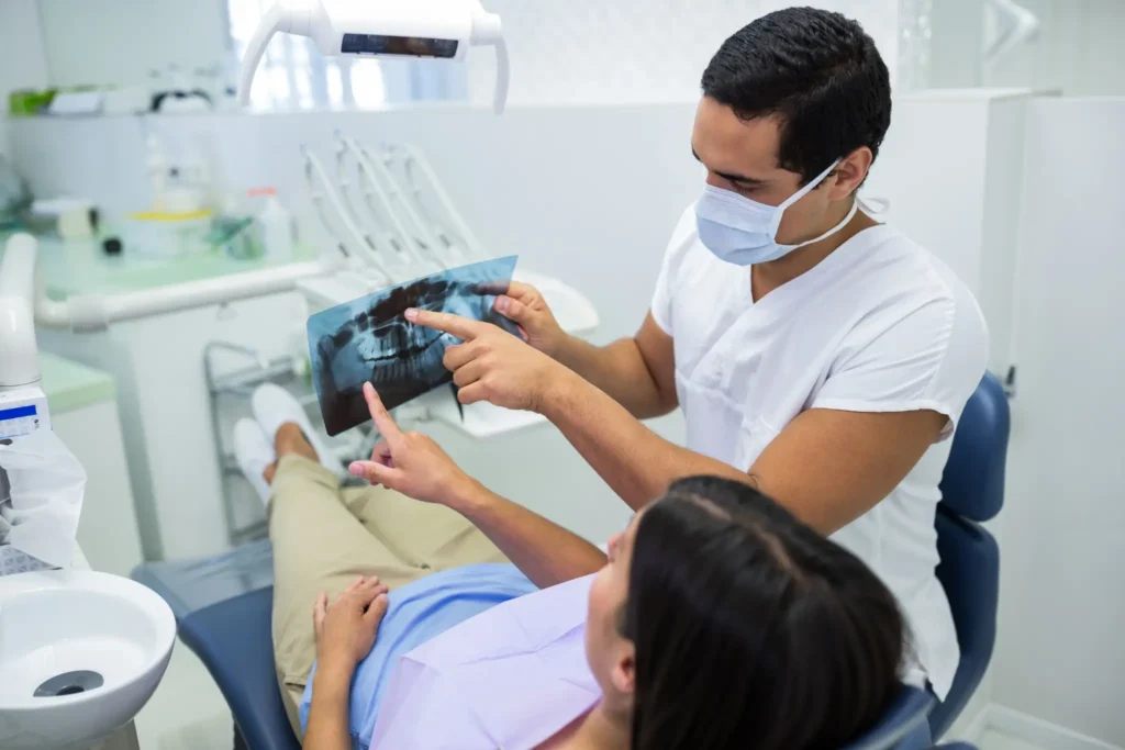 A dentist showing a dental X-ray to a patient during a consultation 