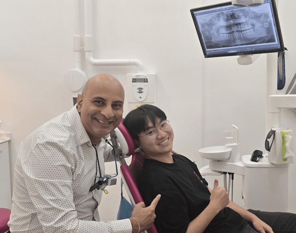 Dr Prashanth with a happy patient after the root canal procedure