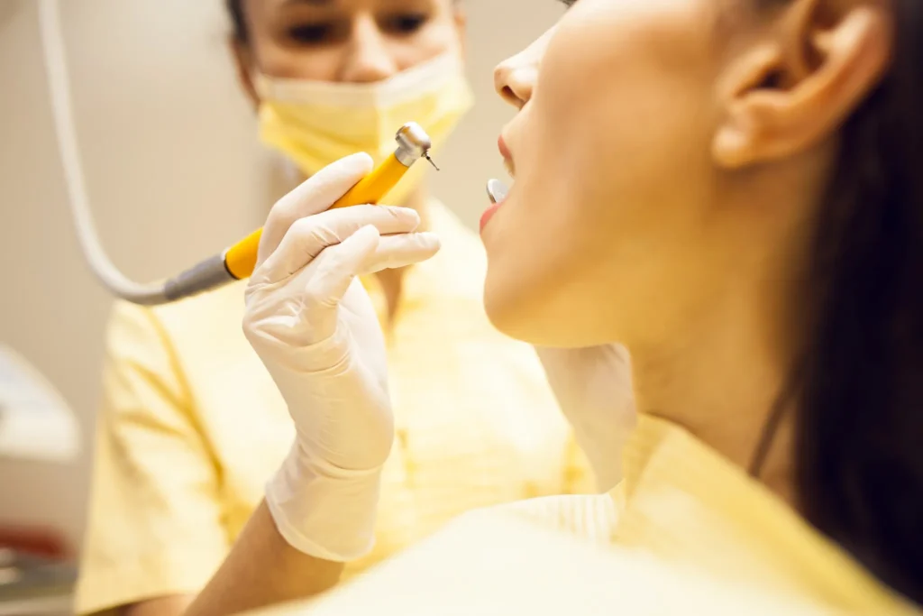 Dentist examining a patient’s teeth during a professional dental check-up before whitening treatment